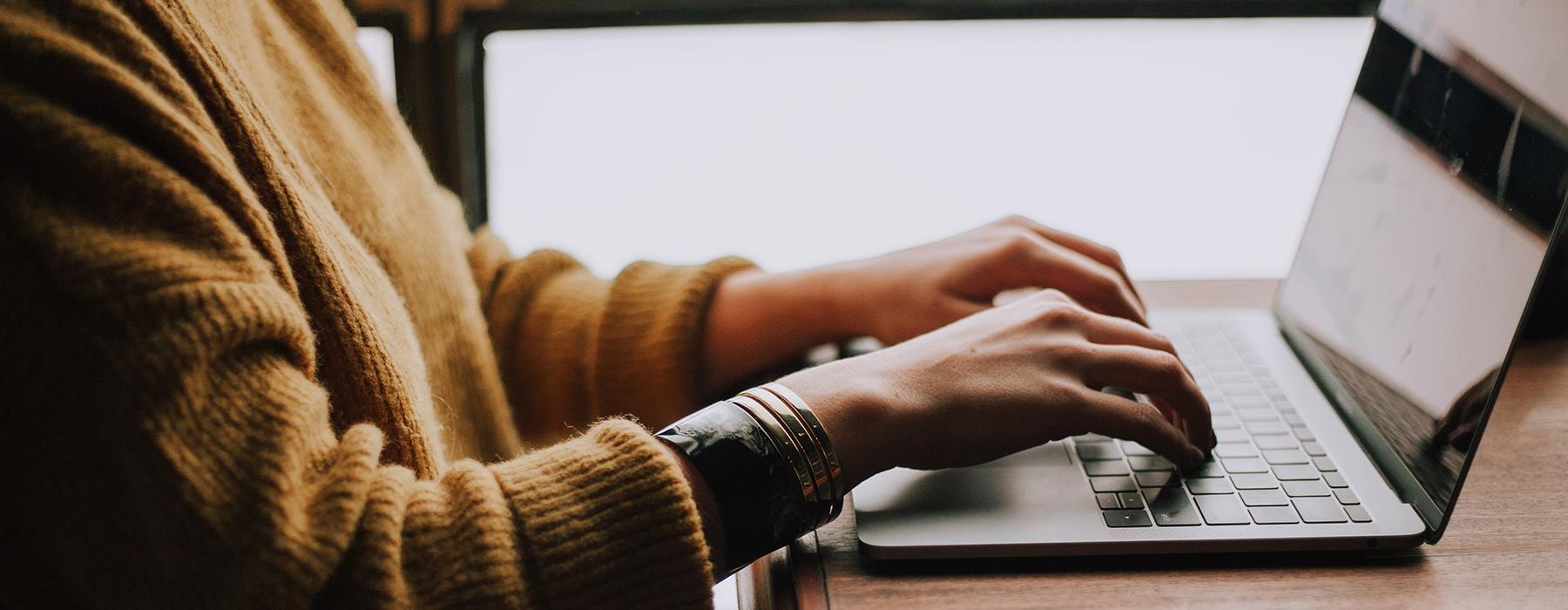 a person typing on a laptop