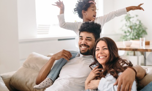 family on a couch with a table behind them